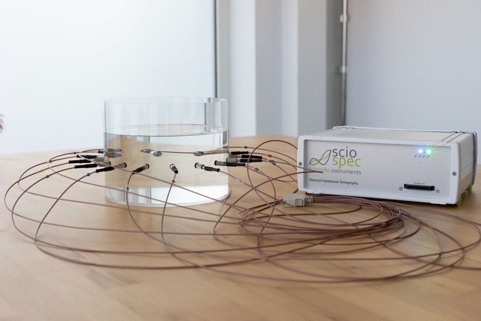 Sciospec EIT32 system connected to a phantom tank with multiple electrodes for bioimpedance applications.