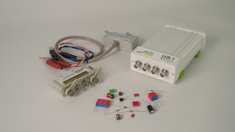 LCR-1 device connected to various electronic components including sensors, capacitors, resistors, and test fixtures.