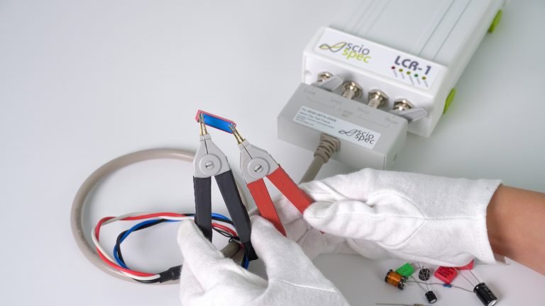LCR-1 impedance analyzer connected to multiple electronic components in a modular test setup. LCR Meters